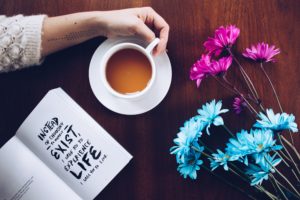 Coffee, flowers, and notebook