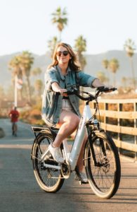 Woman biking on a boardwalk