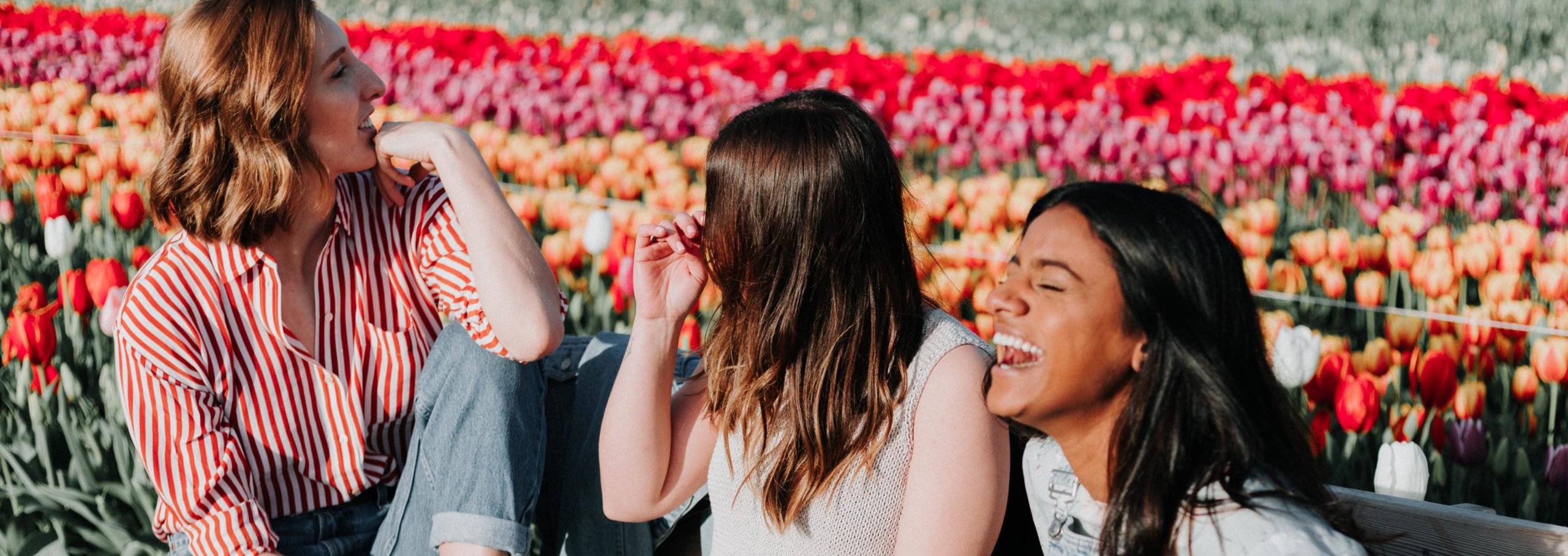 Three young women laughing